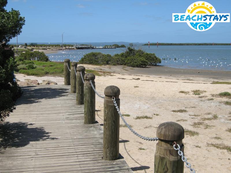 Coastline and beach with boat ramp in the distance